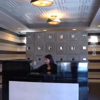 A person working at the reception desk in a modern office interior.