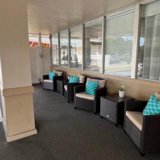 Comfortable outdoor seating area with cushioned chairs and turquoise pillows.