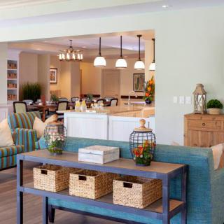 A spacious open-concept living area featuring modern furniture and home decor elements.