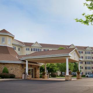 A welcoming entrance of a hotel showcasing a modern architectural design.