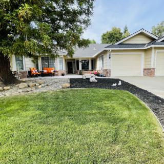 A suburban house with a well-maintained lawn and driveway.