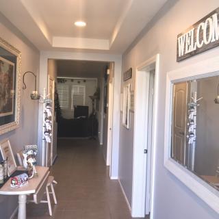 A welcoming hallway with decorative elements and a mirror.