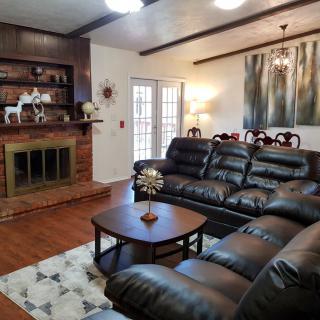 Cozy living room featuring a leather sofa, fireplace, and elegant decor.