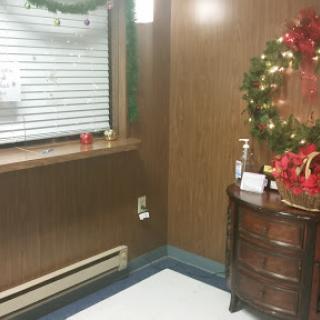 A cozy corner decorated for the holiday season with a festive wreath and seasonal decor.