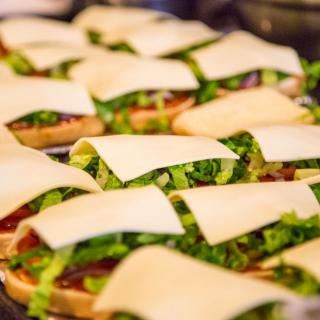 Delicious sandwiches topped with fresh lettuce and cheese slices.