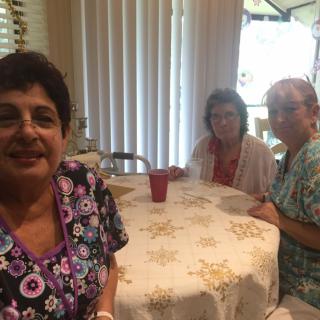 A group of people sitting around a table indoors.