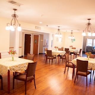 A cozy dining area with neatly arranged tables and warm lighting.