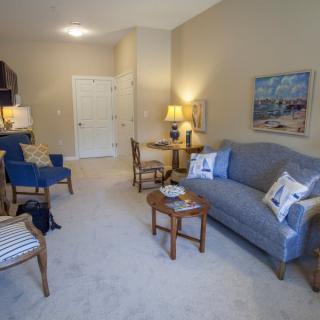A cozy living room with comfortable seating and warm lighting.