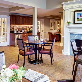 A cozy and elegantly decorated living and dining area with a fireplace.