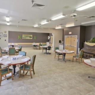 An empty dining room with neatly arranged tables and chairs.