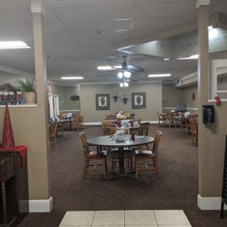 A spacious dining area with tables and chairs, designed for communal meals.