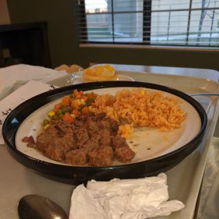 A plate of savory beef with rice and mixed vegetables, ready for a delicious meal.