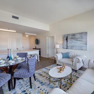 A modern living and dining area with stylish furniture and bright lighting.