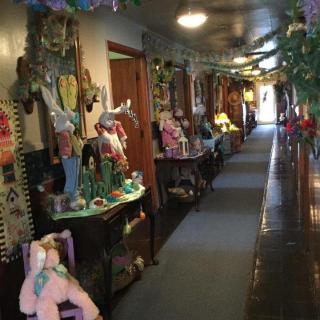 A hallway adorned with colorful dolls and festive decorations.