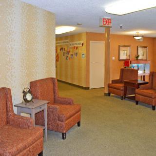A cozy waiting area with comfortable chairs and a hallway leading further inside.