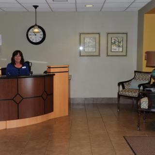 An office lobby with a reception desk and a seating area.