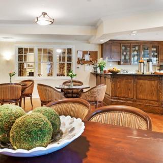 A cozy kitchen and dining area featuring wooden furniture and soft lighting.