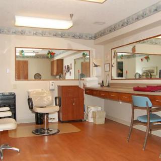 An interior view of a salon with styling chairs and large mirrors.