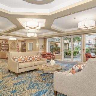 A spacious hotel lobby featuring modern decor with comfortable seating and elegant lighting.