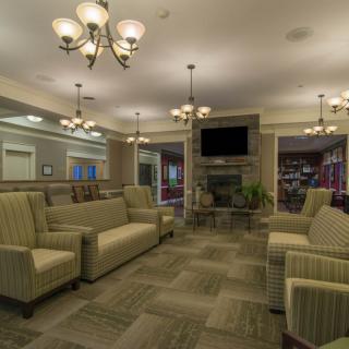 A stylish lounge area featuring comfortable sofas and elegant chandeliers.