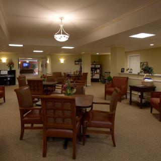 A spacious and well-lit dining area with multiple tables and chairs.