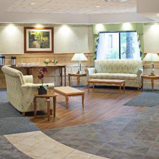 A cozy lobby area featuring sofas and a coffee table, with soft lighting enhancing the welcoming atmosphere.