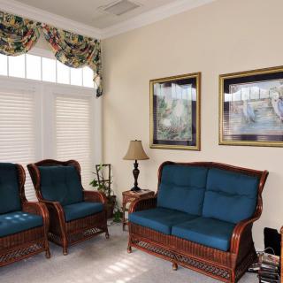 A cozy living room with upholstered furniture and decorative elements.