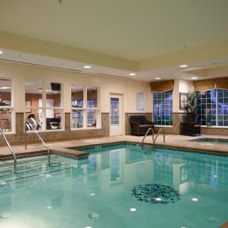An inviting indoor swimming pool area with jacuzzi and fitness facilities, designed for relaxation and wellness.