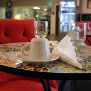 A cozy cafe setting with a coffee cup and napkin on a beautifully decorated table.