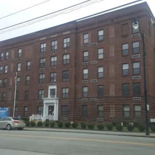 A brick apartment building in an urban setting.