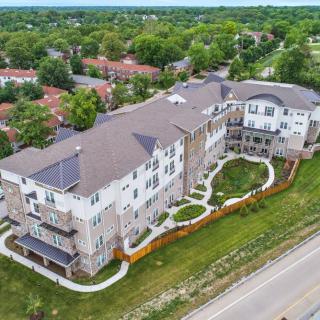 Aerial view of a suburban residential apartment complex surrounded by greenery.