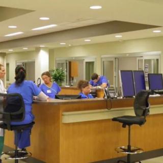 Medical staff working at a hospital nurse station.