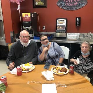 A cozy gathering at a dining table, enjoying a meal together.