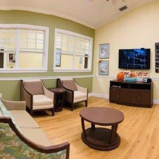 A cozy waiting room with comfortable seating and a television.