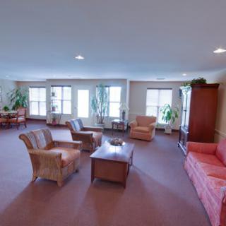 A spacious living room with comfortable seating and large windows.
