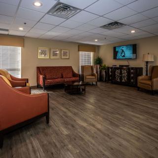 A comfortable living room with sofas, chairs, and a television.
