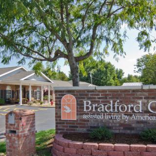 A view of a retirement community with a sign reading 'Bradford Court senior living by Americare.'