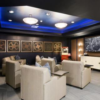 A modern home theater with plush seating and ambient lighting.