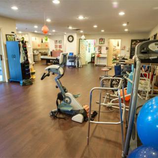 A well-equipped rehabilitation and fitness center with exercise machines and therapy equipment.
