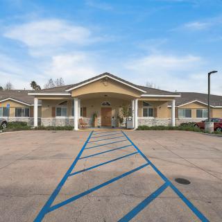 A single-story building with a welcoming entrance and accessible parking spaces in front.