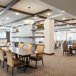 Modern dining area with stylish furniture and lighting.