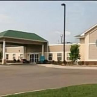 A building with a large entrance and driveway.