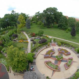 Aerial view of a beautifully landscaped garden with pathways and lush greenery.