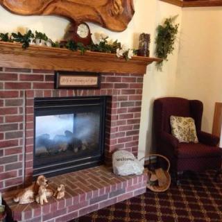 A cozy living room with a brick fireplace and comfortable seating.