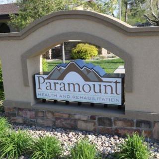 Entrance sign for the Paramount community surrounded by landscaping.
