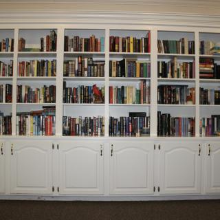 A large built-in bookshelf filled with a variety of books.