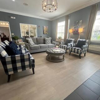 A stylish and modern living room featuring a cozy seating arrangement with plaid patterned chairs and elegant lighting.