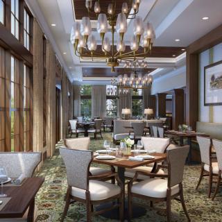 A luxurious restaurant interior featuring elegant chandeliers and sophisticated table settings.