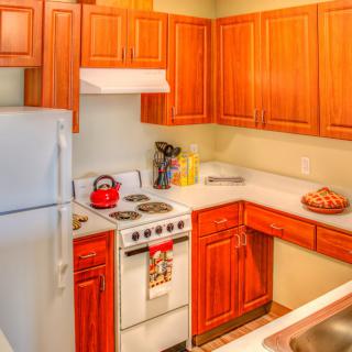 A cozy kitchen with wooden cabinets and modern appliances.