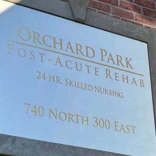 Sign for Orchard Park Post-Acute Rehab, indicating 24-hour skilled nursing at 740 North 300 East.